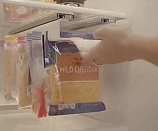 zip n store a slide out holder for ziploc bags in the fridge thumb Amazing Kitchen Gadgets That Will Make Your Life Easier These amazing kitchen gadgets that will make your life easier are going to blow your mind.  Seriously, you're going to want all of these kitchen gadgets to make your life easier when it comes to dinner time and cleaning up!